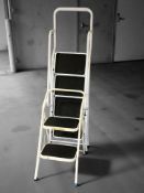 Two sets of folding metal steps