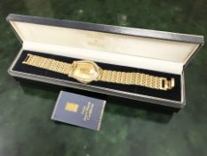 A gent's Credit Suisse gold plated wristwatch with 1g fine gold ingot dial,