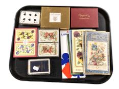Several sets of playing cards, bridge books.
