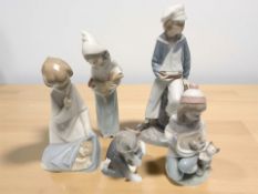 A Lladro figure of a boy dressed as a sailor, together with four further LLadro figures,