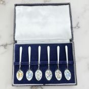 A cased set of six silver and enamel teaspoons