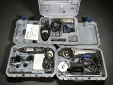 Three dremel tools in boxes