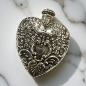 A heart-shaped silver perfume bottle,