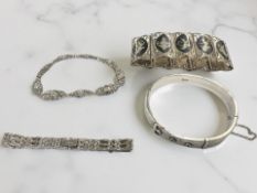 Four silver bracelets/bangles including niello etc CONDITION REPORT: 103g