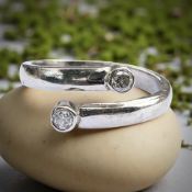 An 18ct gold two-stone diamond crossover ring, size O CONDITION REPORT: 4.