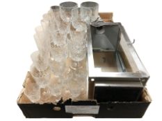 A group of assorted drinking glasses and a hanging candle lantern.