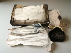 A vintage parasol, together with linen baby gowns, an ostrich feather hand fan,