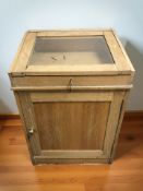 A glazed oak display cabinet with lockable top, with key and cupboard beneath,