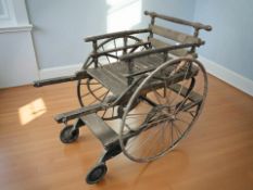 An antique ebonised wheelchair, length 110 cm.