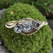 An 18ct gold and platinum three stone diamond ring, size L CONDITION REPORT: 1.