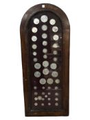 A glazed montage of British coins including silver examples, various crowns and shillings, etc,