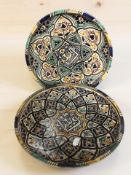 A pair of Islamic Faience earthenware wall plates,