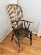 A 19th century elm spindle back Windsor kitchen armchair, width 53 cm.