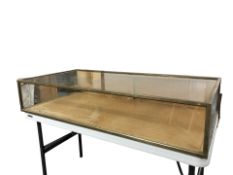 A brass framed glass counter top display cabinet, 122 cm x 60 cm x 23 cm.