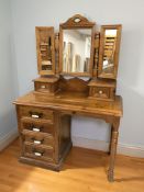 A modern pine single pedestal four drawer dressing table with mirror above, 105 cm x 50 cm x 157 cm.