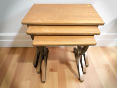A Nathan nest of three teak tables, width 61 cm.