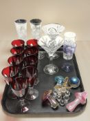 A group of nine ruby drinking glasses, together with iridescent mushroom paperweights,