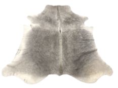 A cow skin rug, approximately 230 cm x 195 cm.