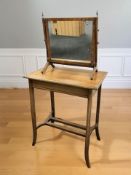 An Edwardian mahogany occasional table, width 61 cm, and a mahogany swing dressing table mirror.