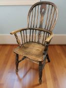 A 19th century elm spindle back Windsor kitchen armchair, width 58 cm.