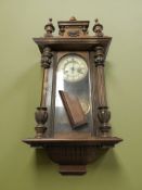 A late 19th century walnut Vienna wall clock.