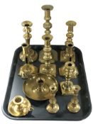 A collection of Victorian and later bass candlesticks, chamber sticks.