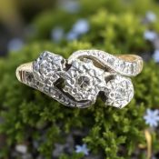 An 18ct gold and platinum three-stone crossover ring, size L CONDITION REPORT: 2.
