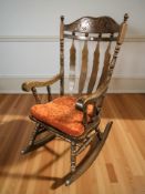 A reproduction beech rocking chair.