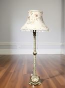 A decorative painted and gilt standard lamp with tasseled shade, height 180 cm.
