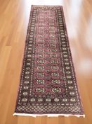 A Lahore Bokhara runner, Pakistan, 254 cm x 82 cm.