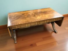 A reproduction mahogany drop leaf coffee table, unextended 106 cm wide.