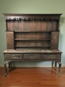 A George III inlaid oak kitchen dresser, 196 cm x 46 cm x 206 cm.