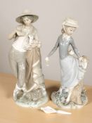 A Lladro figure of a shepherd holding a lamb, and another of a lady with parasol.