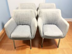 A set of four contemporary armchairs in blue upholstery on chrome legs.