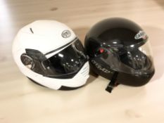 A Premier motorcycle helmet size 10 and a Kaberg helmet.