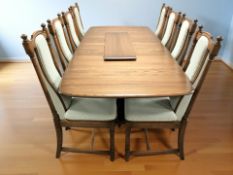 An Ercol stained elm extending dining table with three leaves,