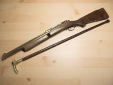 An American Benjamin Franklin break-action air rifle, together with a brass handled walking stick.