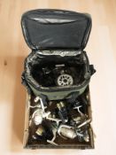 A fishing bag and a collection of reels including Ganza, Matrix, Stillwater, Shakespeare, etc.