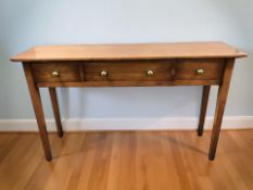 A reproduction three drawer hall table, 130 cm x 36 cm x 76 cm.