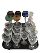 A set of five coloured hock glasses, several other drinking glasses and a decanter.