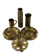 A group of inert brass shells, a trench art table lighter, two ashtrays, etc.