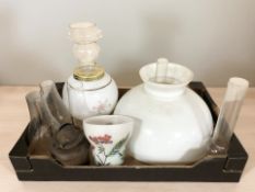 A group of oil lamp parts including several chimneys, shades, etc.