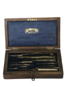 A Victorian rosewood case of brass drawing instruments.