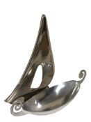 A stainless steel twin handled dish, width 53 cm, and a further similar model sailboat.