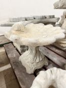 A concrete garden shell bird bath, height 41 cm.