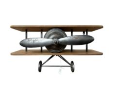 A contemporary wall shelf in the form of a bi-plane, width 60 cm.