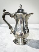 A George III silver coffee pot, John Langlands I, Newcastle 1770, engraved with a family crest,