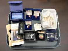 A collection of gold-plated commemorative coins and tokens, paperweights,