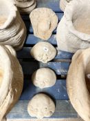 Three concrete garden smiling face stones, largest 21 cm wide, and a further maiden wall pocket.