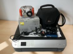 Olympus and Nikon digital cameras, together with a Nikon waterproof camera case and an HP scanner.